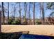 View of the backyard featuring grass and trees at 5652 Plain Field Ln, Lilburn, GA 30047