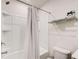 Simple bathroom with a shower-tub combo and convenient towel rack at 5652 Plain Field Ln, Lilburn, GA 30047