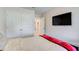 This bedroom features a comfortable bed, a large closet, and a mounted TV for relaxing evenings at 5652 Plain Field Ln, Lilburn, GA 30047