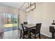 Cozy dining area featuring a modern chandelier and sliding glass door to the outdoors at 5652 Plain Field Ln, Lilburn, GA 30047
