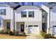 Charming townhome featuring a one-car garage and a well-maintained front yard at 5652 Plain Field Ln, Lilburn, GA 30047