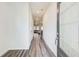 Bright hallway leads to living area, showcasing modern flooring and design at 5652 Plain Field Ln, Lilburn, GA 30047