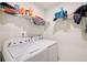 Functional laundry room with shelving and a white washer and dryer set at 5652 Plain Field Ln, Lilburn, GA 30047