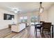Living and dining area featuring stylish flooring and modern lighting at 5652 Plain Field Ln, Lilburn, GA 30047