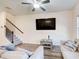 Bright and airy living room with a ceiling fan and staircase at 5652 Plain Field Ln, Lilburn, GA 30047