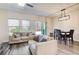 Bright living room and dining area featuring large windows and sliding glass door at 5652 Plain Field Ln, Lilburn, GA 30047