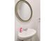 Modern half bathroom featuring a stylish sink and neutral decor at 5652 Plain Field Ln, Lilburn, GA 30047