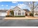 Charming brick home featuring a well-manicured lawn and attached garage at 10104 Windrush Ln, Alpharetta, GA 30009