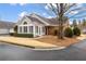 Charming single-story home with brick and siding exterior, landscaped yard and American flag at 10104 Windrush Ln, Alpharetta, GA 30009