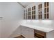 Kitchen with white cabinets, stainless steel oven, quartz countertops, and under cabinet lighting at 10104 Windrush Ln, Alpharetta, GA 30009