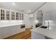 Elegant kitchen featuring custom cabinetry, stainless steel appliances, and a breakfast bar at 10104 Windrush Ln, Alpharetta, GA 30009