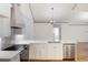 Modern kitchen features stainless steel appliances, white cabinets, quartz counters, and a decorative backsplash at 10104 Windrush Ln, Alpharetta, GA 30009