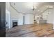 Open-concept living area with fireplace, hardwood floors, and seamless flow into the kitchen at 10104 Windrush Ln, Alpharetta, GA 30009