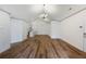 Spacious open-concept area with sleek wood floors flowing into a modern kitchen and dining space at 10104 Windrush Ln, Alpharetta, GA 30009