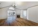 Bright living room featuring hardwood floors, fireplace, and plenty of natural light at 10104 Windrush Ln, Alpharetta, GA 30009