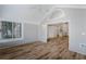 Bright sunroom featuring wood floors, shiplap walls, and seamless access to other rooms at 10104 Windrush Ln, Alpharetta, GA 30009