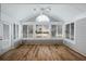 Cozy sunroom bathed in natural light with walls of windows, offering serene views at 10104 Windrush Ln, Alpharetta, GA 30009
