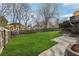 Well-manicured backyard with stone retaining wall, large grass area, privacy fence, and storage shed at 10475 Willow Meadow Cir, Alpharetta, GA 30022