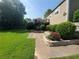 Green backyard features a stone retaining wall, mature landscaping, privacy fence, and a deck at 10475 Willow Meadow Cir, Alpharetta, GA 30022