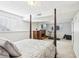 Basement bedroom featuring a four-poster bed, TV, fireplace, treadmill, and a window for natural light at 10475 Willow Meadow Cir, Alpharetta, GA 30022