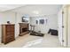 Basement bonus room with fireplace, TV, chest of drawers, treadmill, weights, and ample space at 10475 Willow Meadow Cir, Alpharetta, GA 30022
