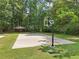 Community basketball court, nestled in a wooded area, with benches and a covered pavilion at 10475 Willow Meadow Cir, Alpharetta, GA 30022