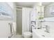 This bathroom offers a shower, window, modern sink, and storage cabinet at 10475 Willow Meadow Cir, Alpharetta, GA 30022