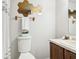 Bathroom featuring vanity with sink, toilet, decor, and a large mirror at 10475 Willow Meadow Cir, Alpharetta, GA 30022