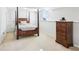 Cozy bedroom with a four-poster bed, neutral carpet, and white walls with a half wall painted the same color at 10475 Willow Meadow Cir, Alpharetta, GA 30022