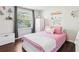 Bright bedroom features hardwood floors, a window, decor, and a wardrobe at 10475 Willow Meadow Cir, Alpharetta, GA 30022