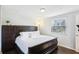 Cozy bedroom features a dark wood bed frame, hardwood floors, and bright natural light at 10475 Willow Meadow Cir, Alpharetta, GA 30022