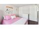 Bright bedroom includes hardwood floors, a butterfly decor wall, and a closet at 10475 Willow Meadow Cir, Alpharetta, GA 30022