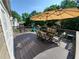 Outdoor deck with a dining table, chairs, umbrella, and exterior lighting at 10475 Willow Meadow Cir, Alpharetta, GA 30022