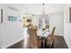 Dining area with a glass top table, upholstered chairs, modern chandelier, and hardwood flooring at 10475 Willow Meadow Cir, Alpharetta, GA 30022