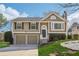 Charming two-story home featuring a well-maintained lawn, two-car garage, and cozy front porch with 'Welcome' sign at 10475 Willow Meadow Cir, Alpharetta, GA 30022