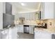 Bright kitchen featuring stainless steel appliances, tile backsplash, granite countertops, and modern white cabinetry at 10475 Willow Meadow Cir, Alpharetta, GA 30022