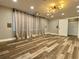 Finished basement with wood-look flooring, recessed lights, and a large window with curtains at 6787 Hembree Dr, Austell, GA 30168