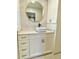 Modern bathroom vanity with drawers and white vessel sink, accented by a round mirror at 6787 Hembree Dr, Austell, GA 30168
