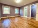 Bedroom with hardwood floors, two windows, closet with wire shelving and light purple walls at 6787 Hembree Dr, Austell, GA 30168