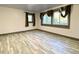 Comfortable bedroom with natural light, features wood-look tile flooring and neutral colors at 6787 Hembree Dr, Austell, GA 30168