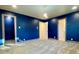 Large bedroom featuring neutral carpet, unique trim, and bright blue walls at 6787 Hembree Dr, Austell, GA 30168