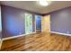 Bedroom with hardwood floors, two windows, and access to a bathroom and walk-in closet at 6787 Hembree Dr, Austell, GA 30168