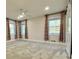 Bright bedroom with neutral carpet, and three windows with decorative curtains at 6787 Hembree Dr, Austell, GA 30168