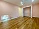 Bedroom with wood floors, a light pink wall, ceiling fan, and a closet with wire shelving at 6787 Hembree Dr, Austell, GA 30168