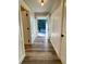 Hallway with white wainscoting and wood-look flooring at 6787 Hembree Dr, Austell, GA 30168