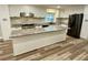 Spacious kitchen island with granite countertop, white cabinets, and stainless steel appliances at 6787 Hembree Dr, Austell, GA 30168
