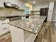 Granite countertop kitchen island with stainless steel appliances and modern fixtures at 6787 Hembree Dr, Austell, GA 30168