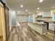 Bright open kitchen featuring a large island, white cabinetry, and modern appliances at 6787 Hembree Dr, Austell, GA 30168