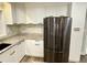 Modern kitchen with stainless steel fridge, white cabinets, and stylish backsplash at 6787 Hembree Dr, Austell, GA 30168