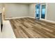 Bright living room with sliding glass doors and wood-look floors at 6787 Hembree Dr, Austell, GA 30168